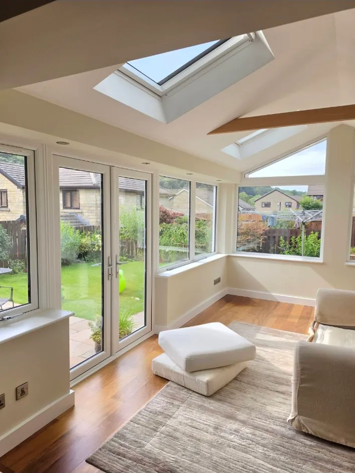 Freshly painted conservatory with rooflights and doors onto the garden