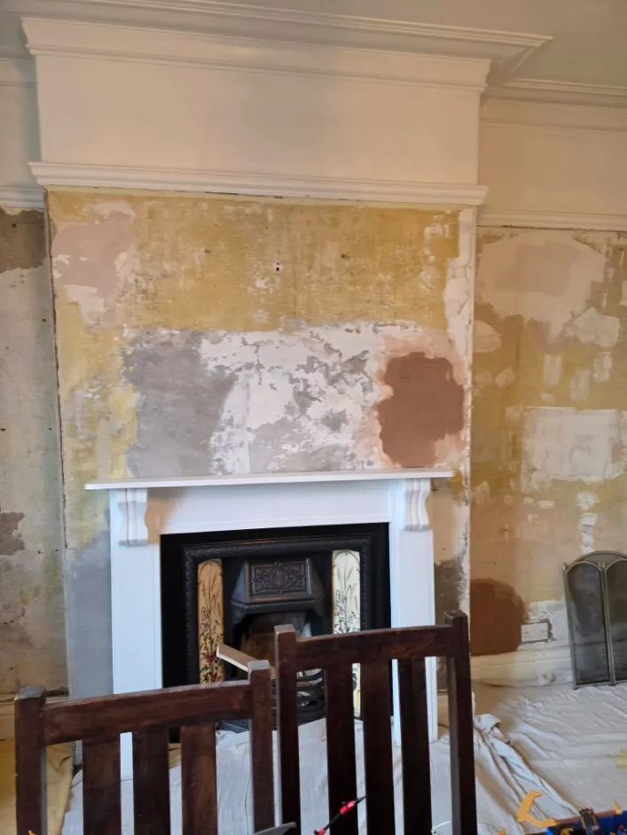 The same dining room before, with stripped and patched walls