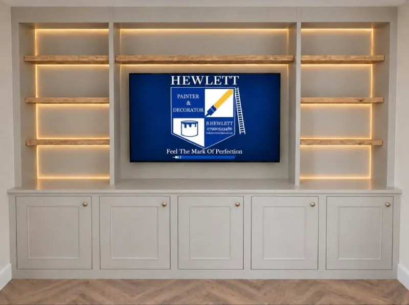 Built in media wall painted in Elephants Breath satinwood with oiled oak shelves and lighting