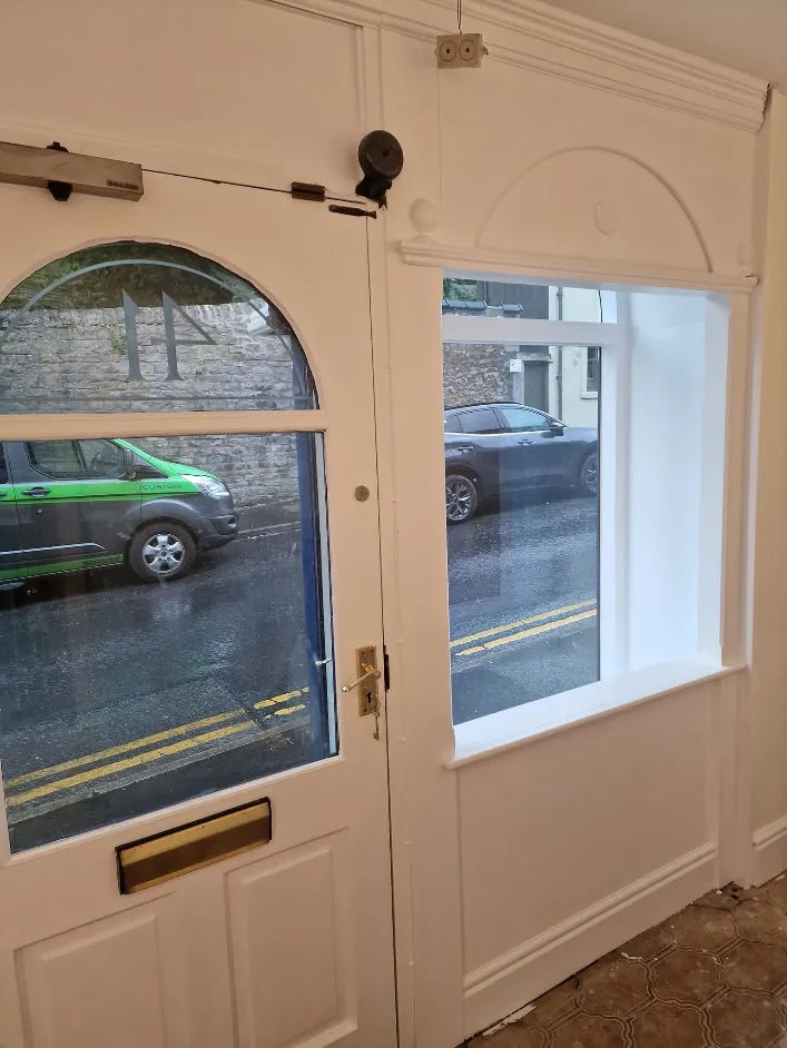 Shop entrance door, window reveals and panelling painted white